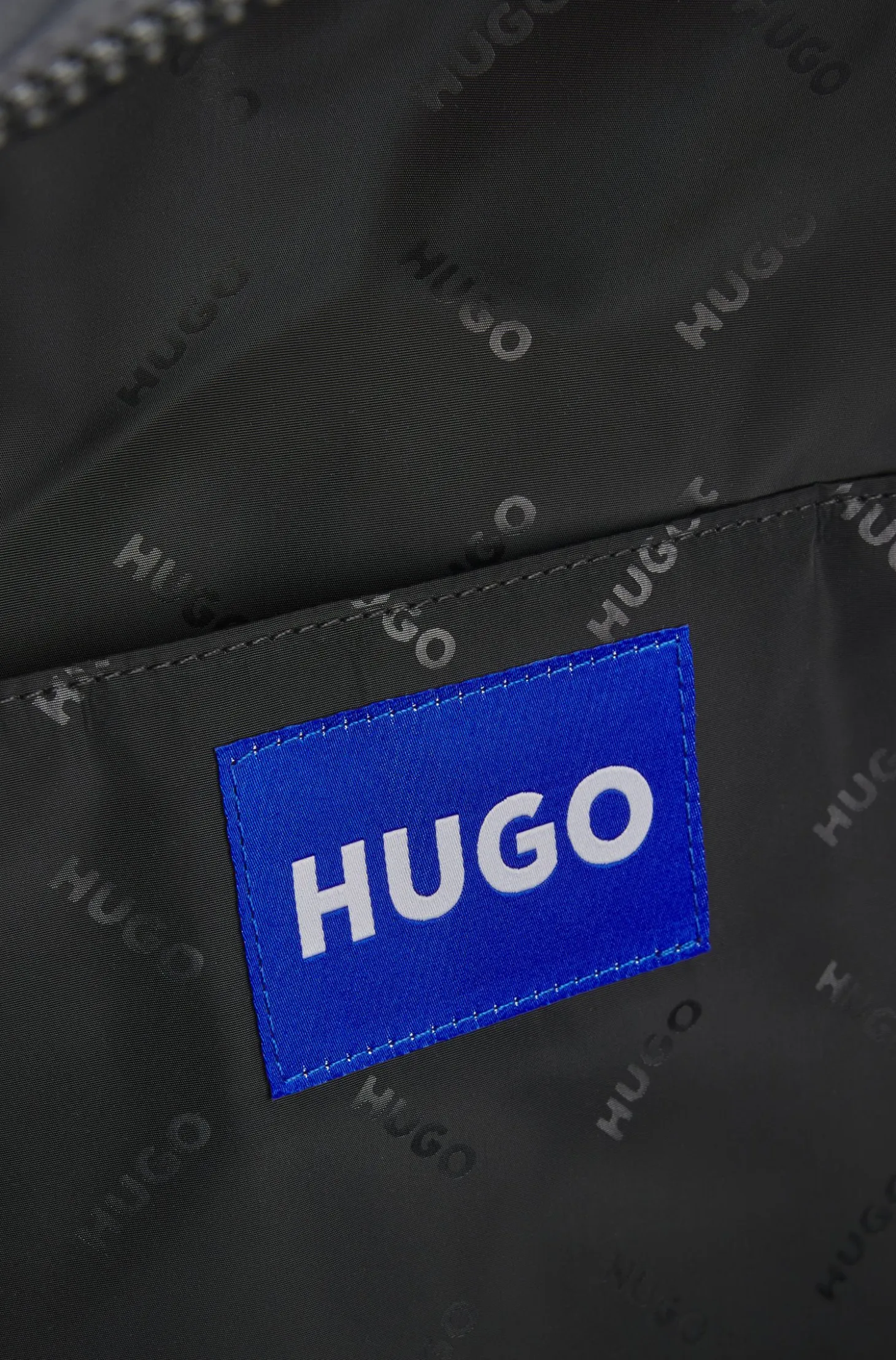 Backpack with blue rubber logo patch