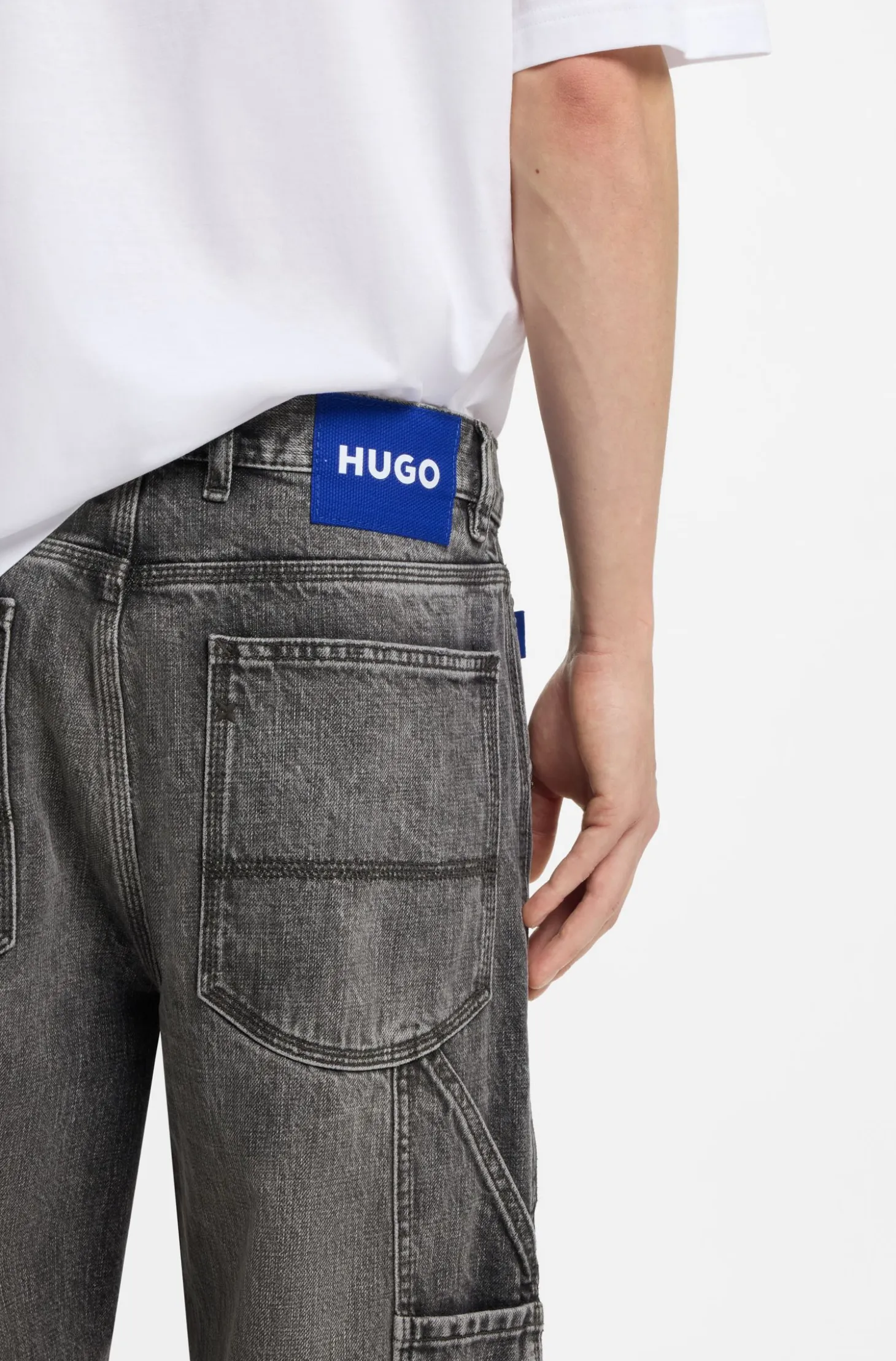 Baggy-fit black jeans with carpenter details