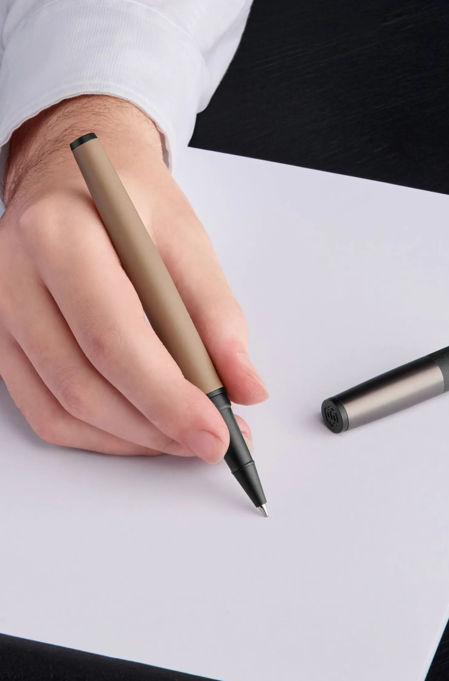 Camel-barrel rollerball pen with logo cap