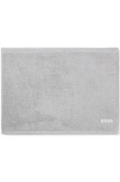 Cotton bath mat with contrast embroidered logo