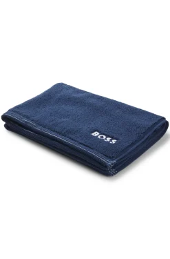 Cotton bath mat with contrast embroidered logo