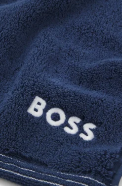 Cotton bath mat with contrast embroidered logo