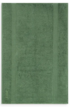 Cotton bath mat with embroidered logo