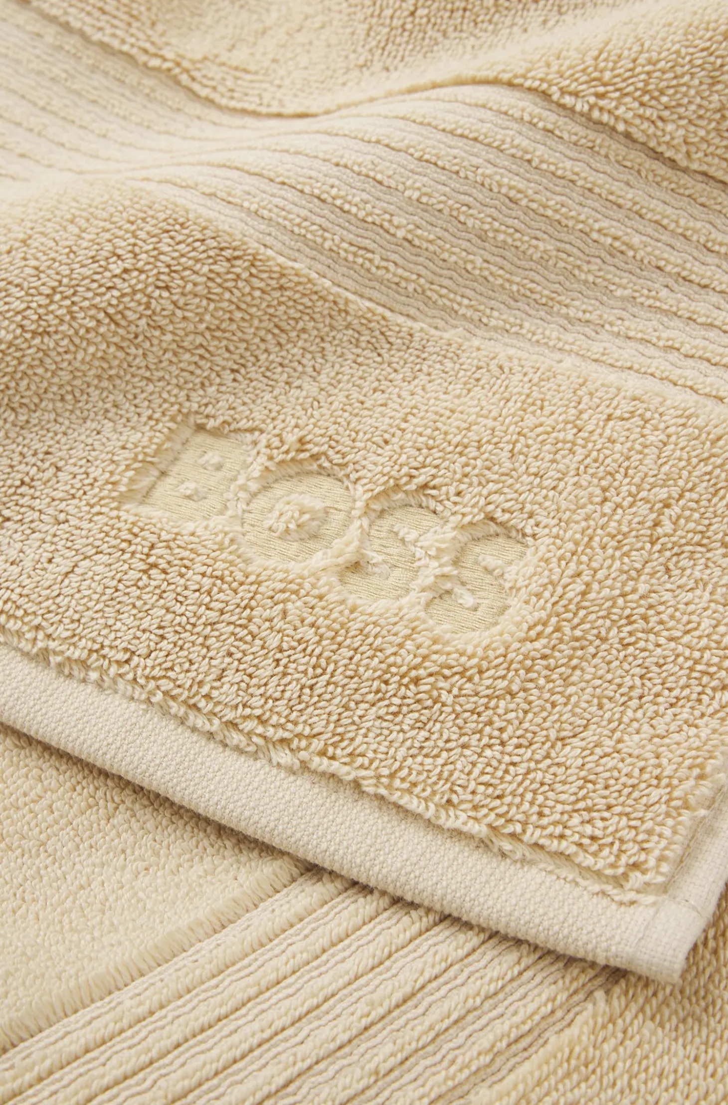 Cotton bath mat with embroidered logo