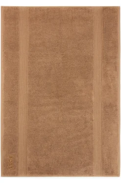 Cotton bath mat with embroidered logo