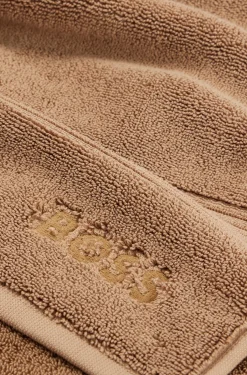 Cotton bath mat with embroidered logo