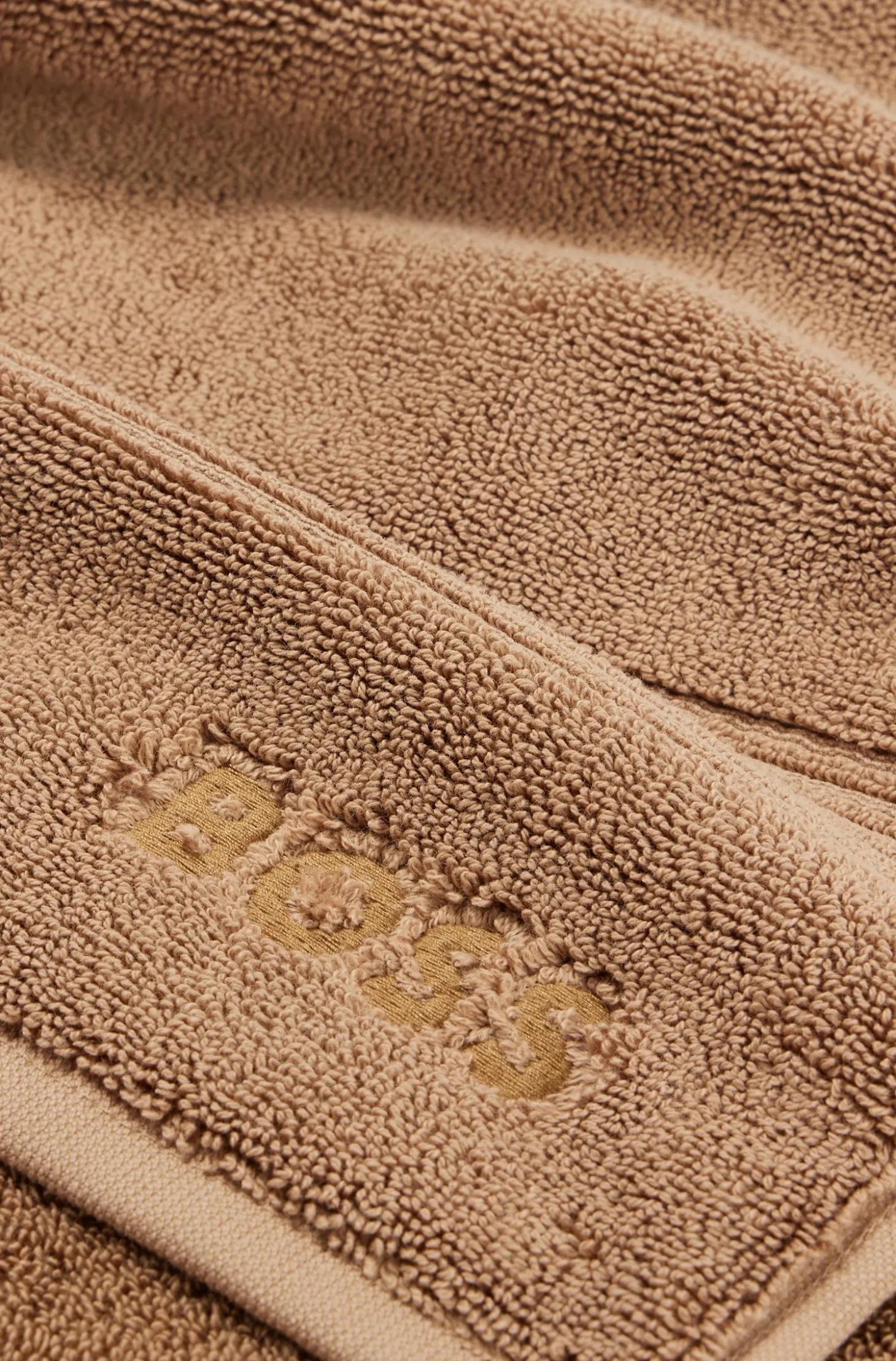 Cotton bath mat with embroidered logo