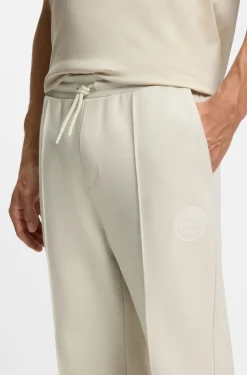 Cotton-blend tracksuit bottoms with tennis-themed logo
