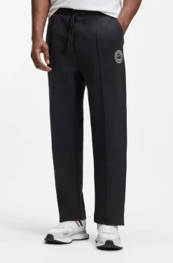 Cotton-blend tracksuit bottoms with tennis-themed logo