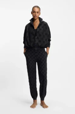 Cotton-blend tracksuit bottoms with all-over logo pattern
