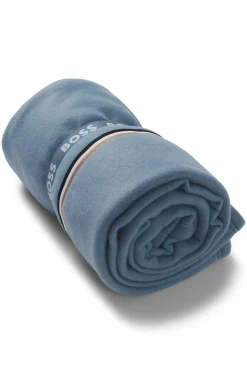 Fleece throw with signature-stripe ribbon