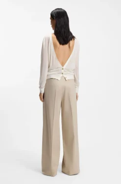 Knitted cardigan with rear button closure