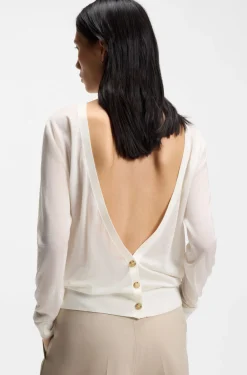 Knitted cardigan with rear button closure