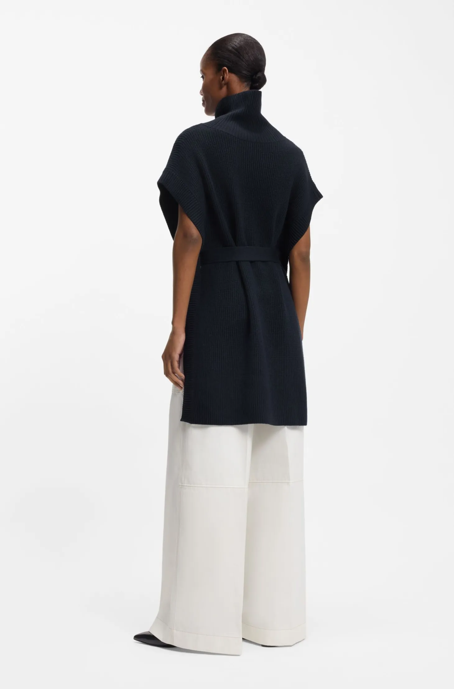 Knitted poncho in virgin wool with high neckline