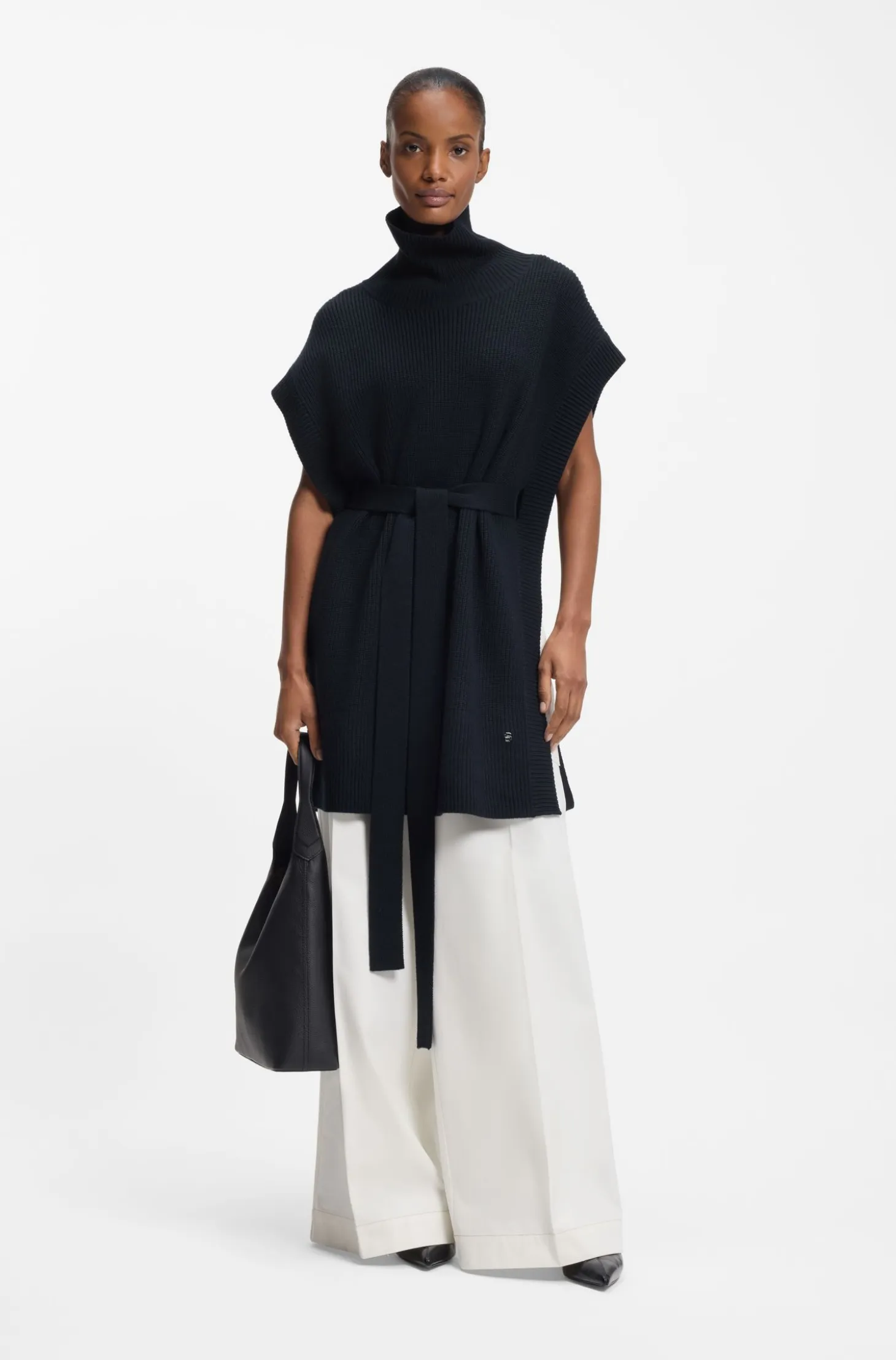 Knitted poncho in virgin wool with high neckline