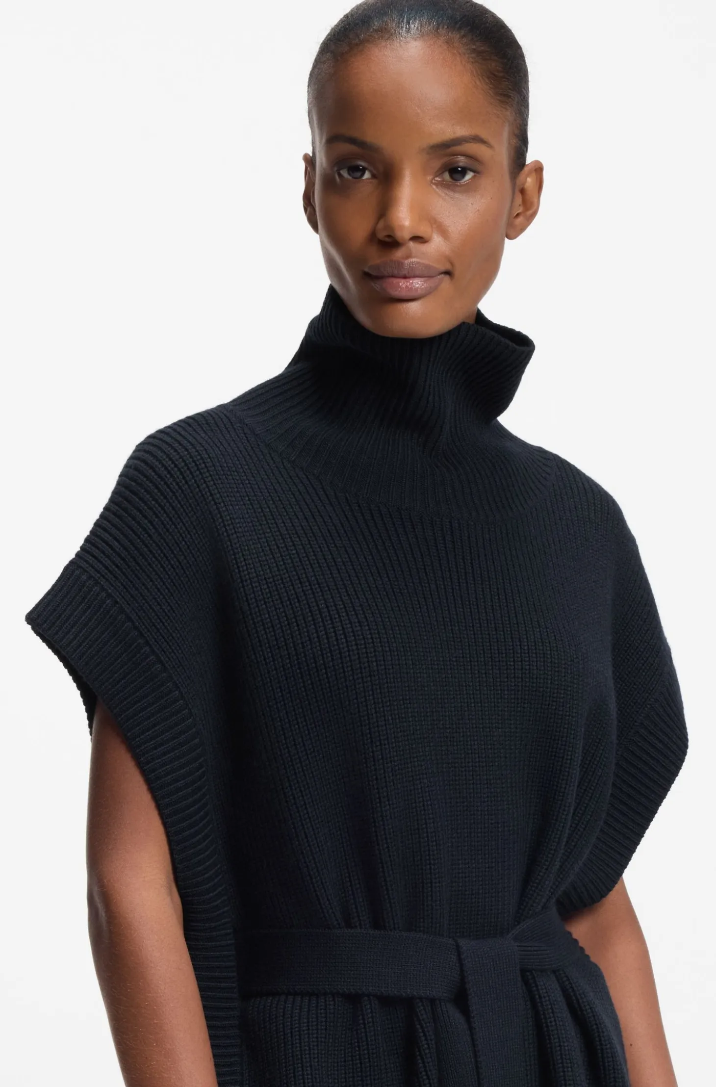 Knitted poncho in virgin wool with high neckline