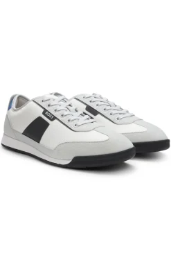 Mixed-material trainers with ridged outsole