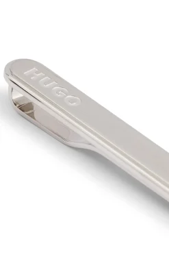 Oval-shaped tie clip with engraved logo