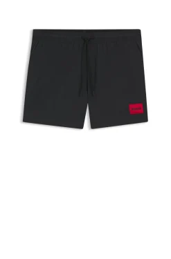 Quick-drying swim shorts with red logo label