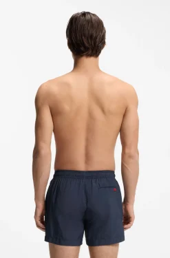 Quick-drying swim shorts with red logo label