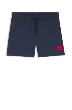 Quick-drying swim shorts with red logo label