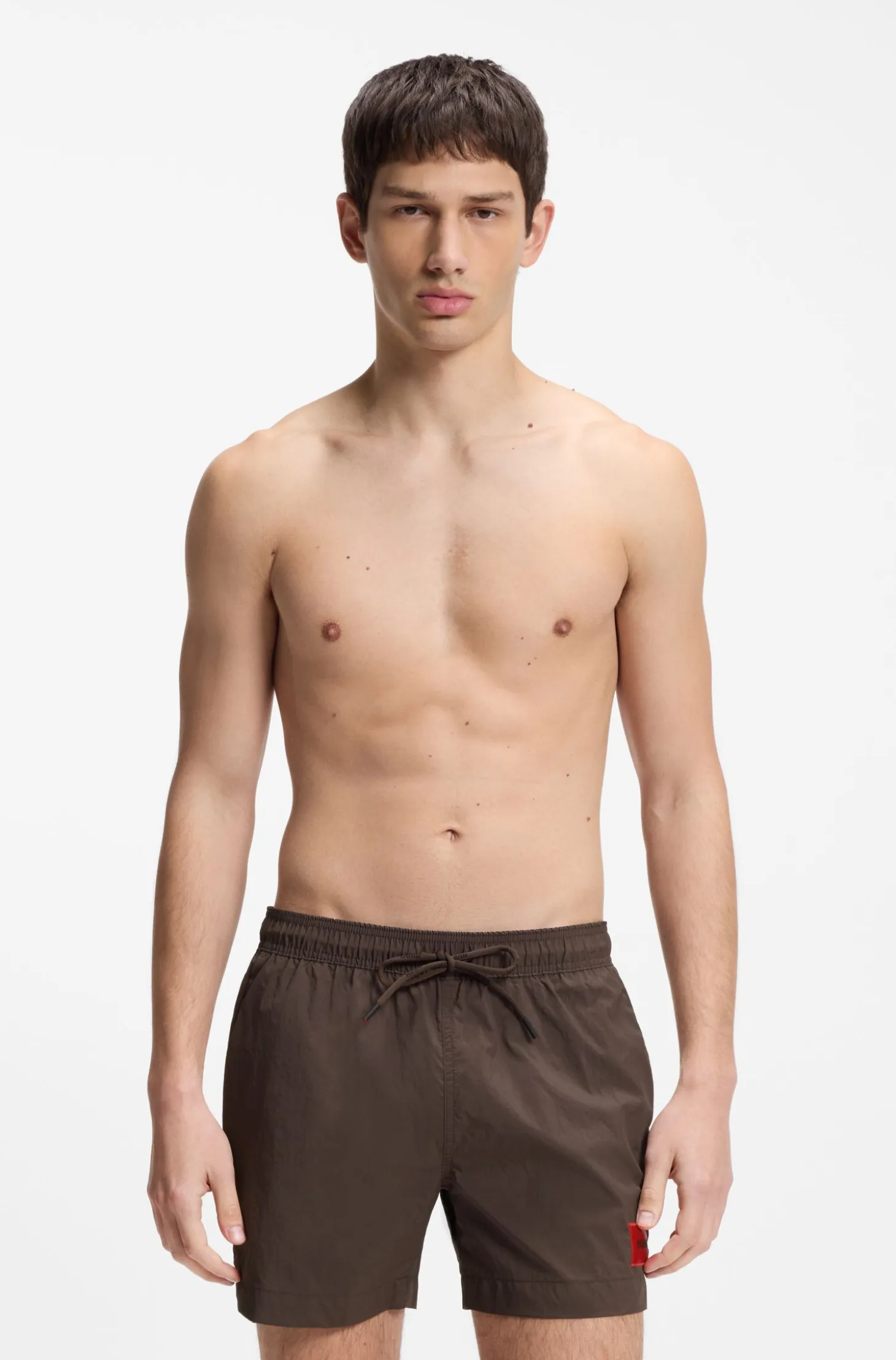 Quick-drying swim shorts with red logo label