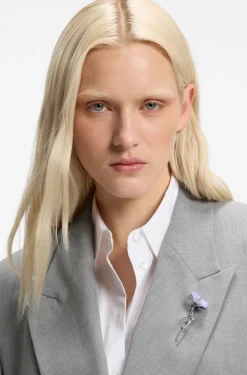 Relaxed-fit blazer with enamel flower brooch
