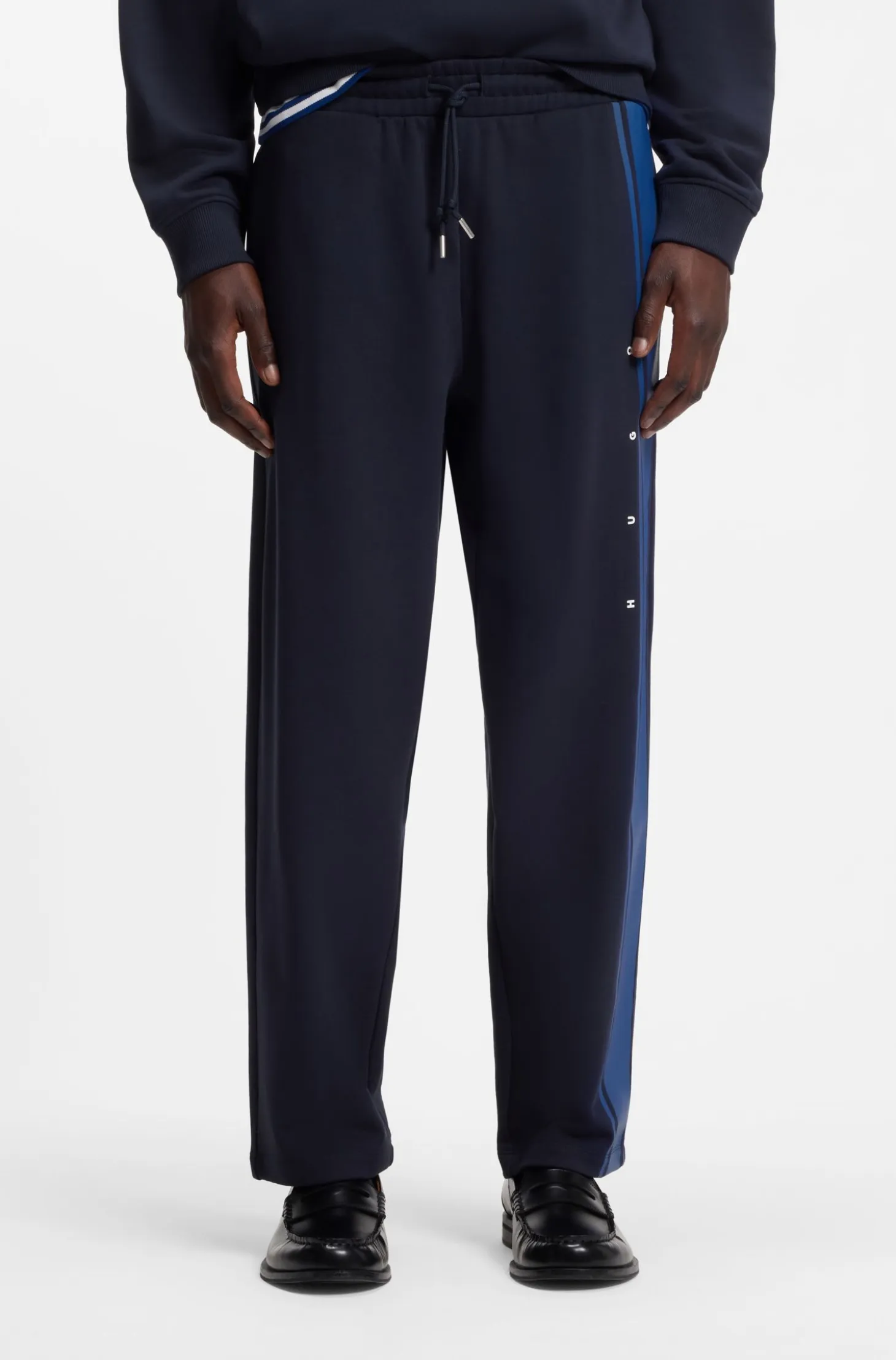 Relaxed-fit tracksuit bottoms in cotton with side stripe
