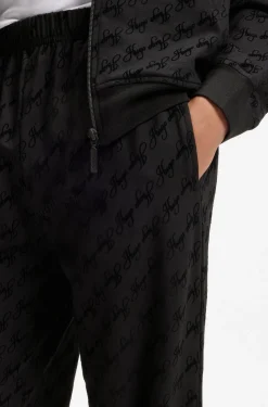 Relaxed-fit tracksuit bottoms with flocked-logo print