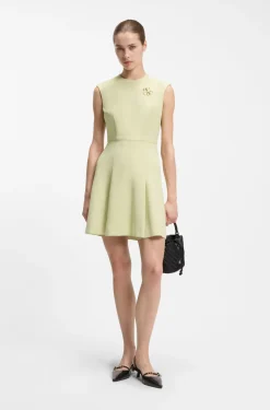 Sleeveless dress with gold-tone flower brooch