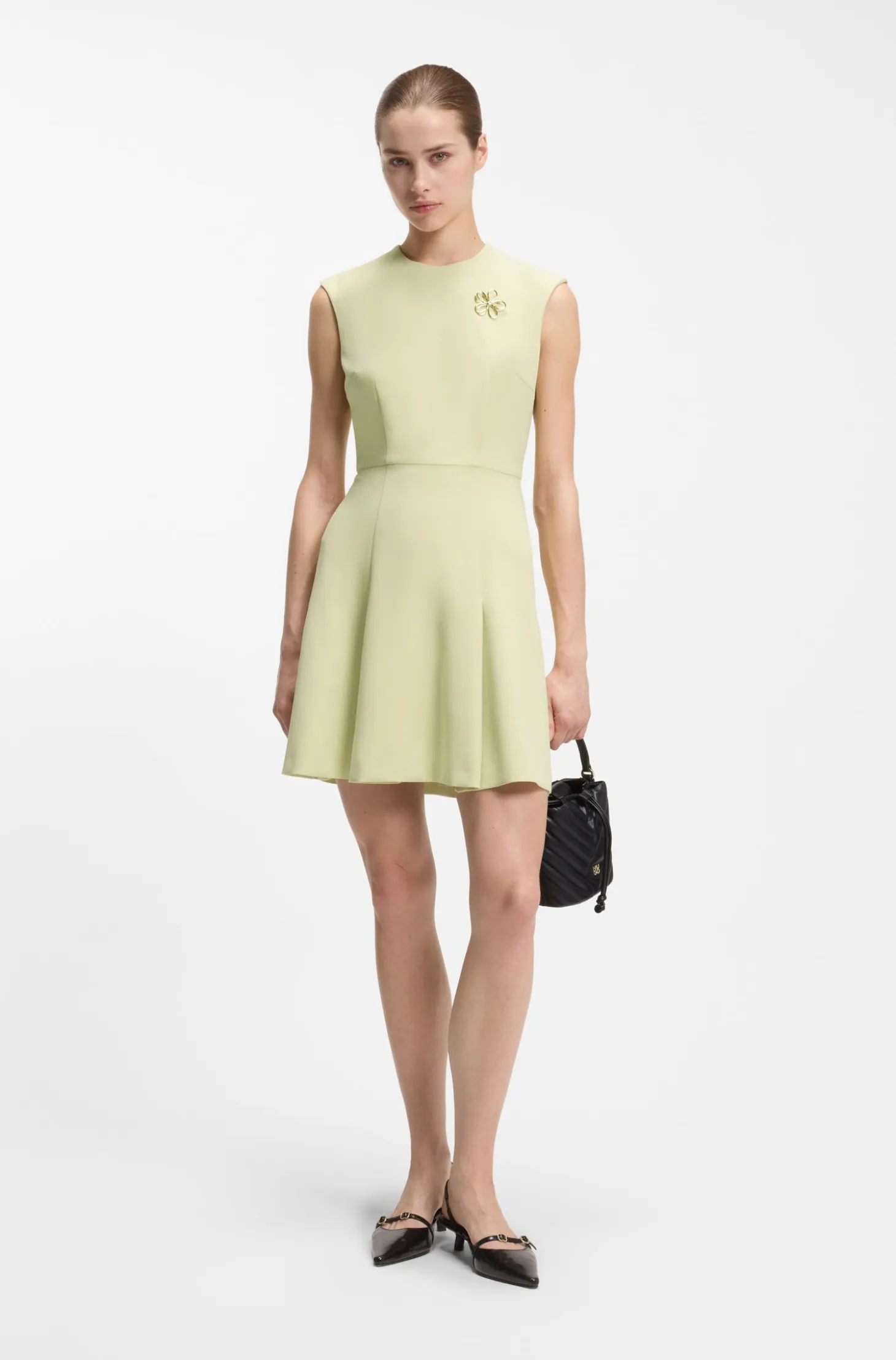 Sleeveless dress with gold-tone flower brooch