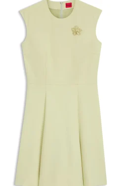 Sleeveless dress with gold-tone flower brooch