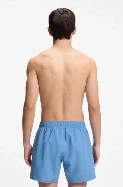 Swim shorts with all-over stacked logos