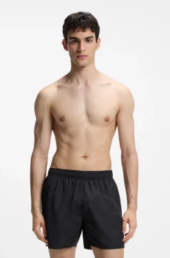 Swim shorts with all-over stacked logos