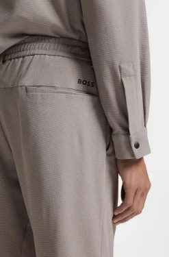 Tapered-fit trousers in waffle-structured stretch fabric