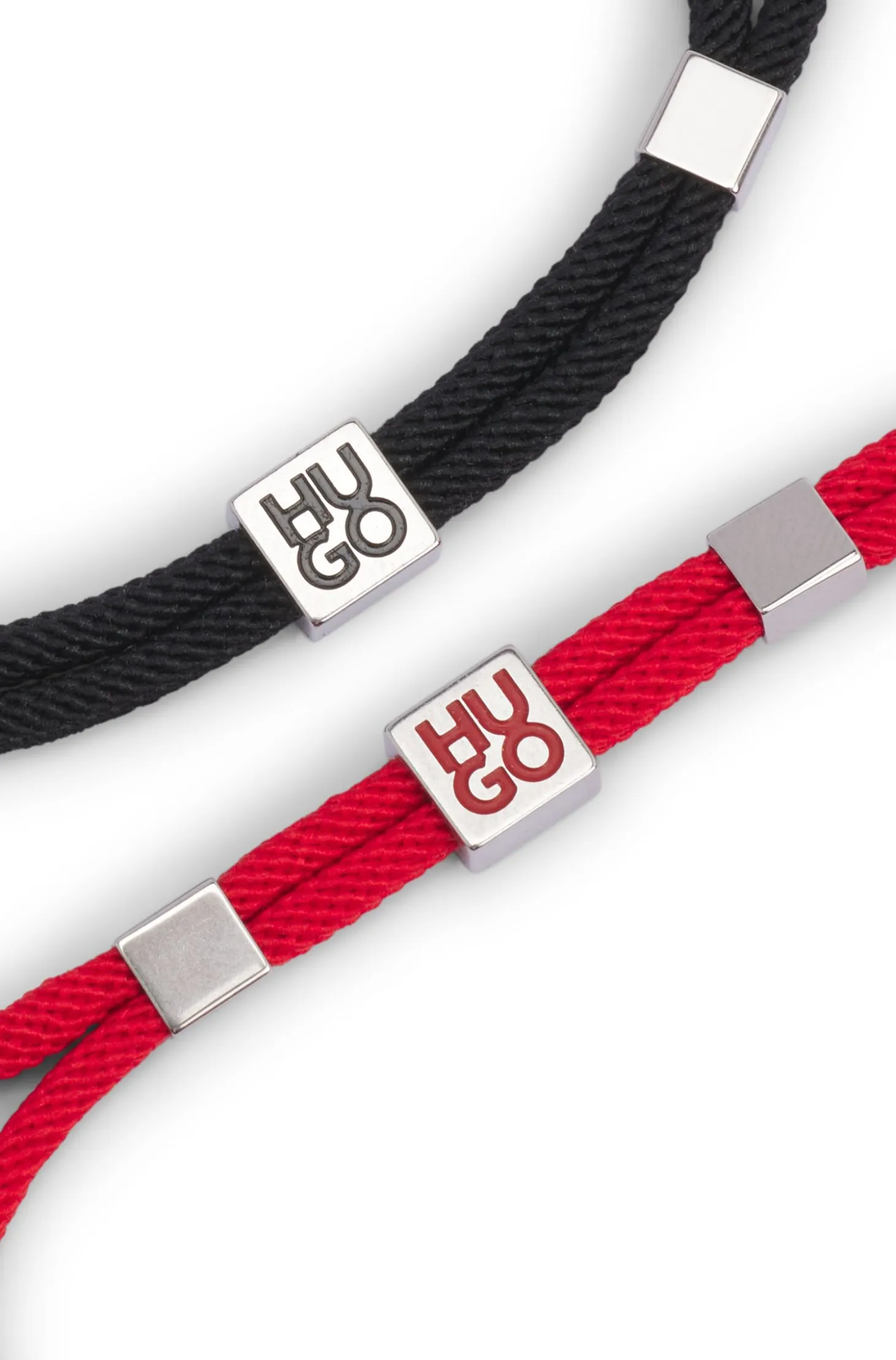 Two-pack of cord cuffs with logo plaques
