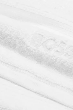 White cotton bath mat with embroidered logo