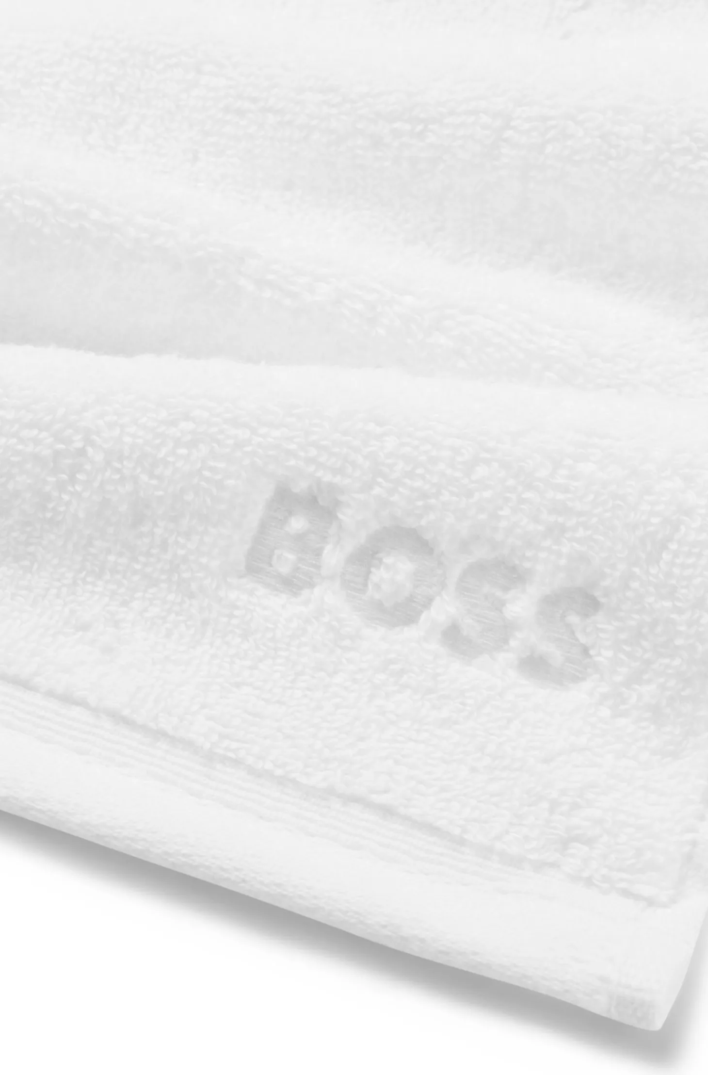 White cotton face cloth with embroidered logo